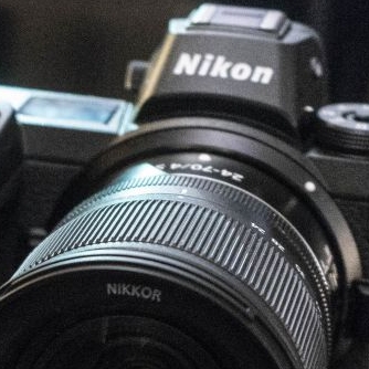 Компания Nikon...